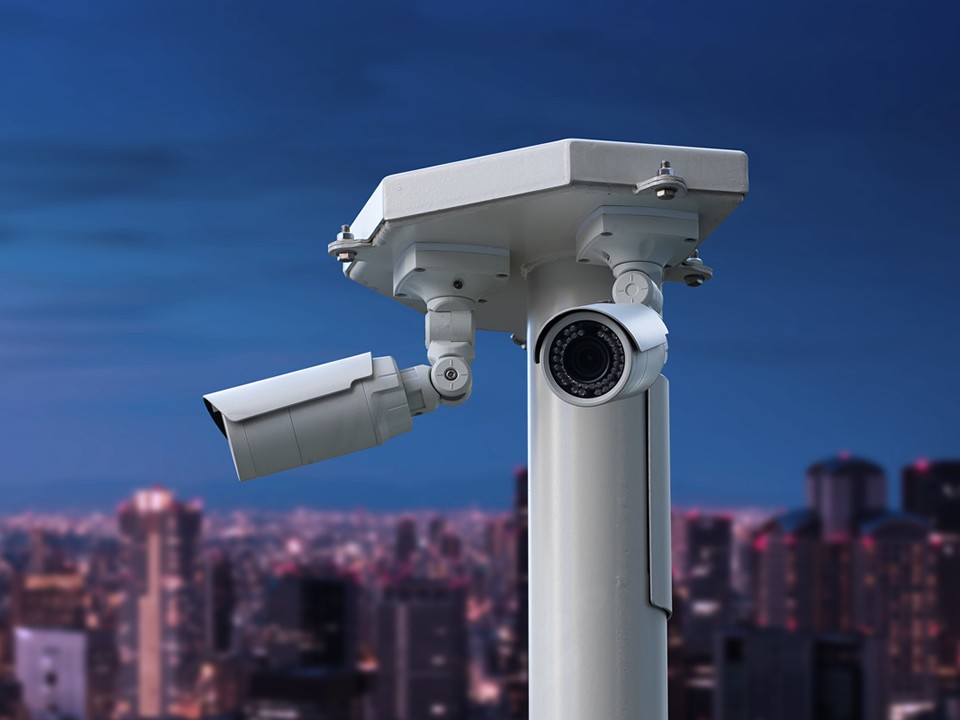 cctv security camera with cityscape at night